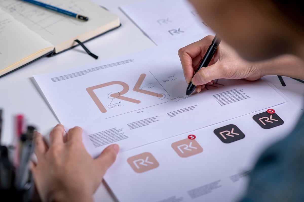 Graphic designer sketching logo concepts by hand while developing a new brand identity